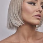Blonde bob wig with side-swept bangs and layered style.
